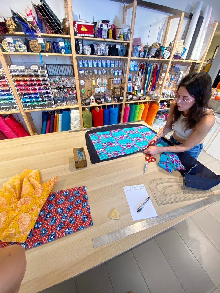 Cutting out tote bag fabric at the haberdashery table at Violet Elizabeth