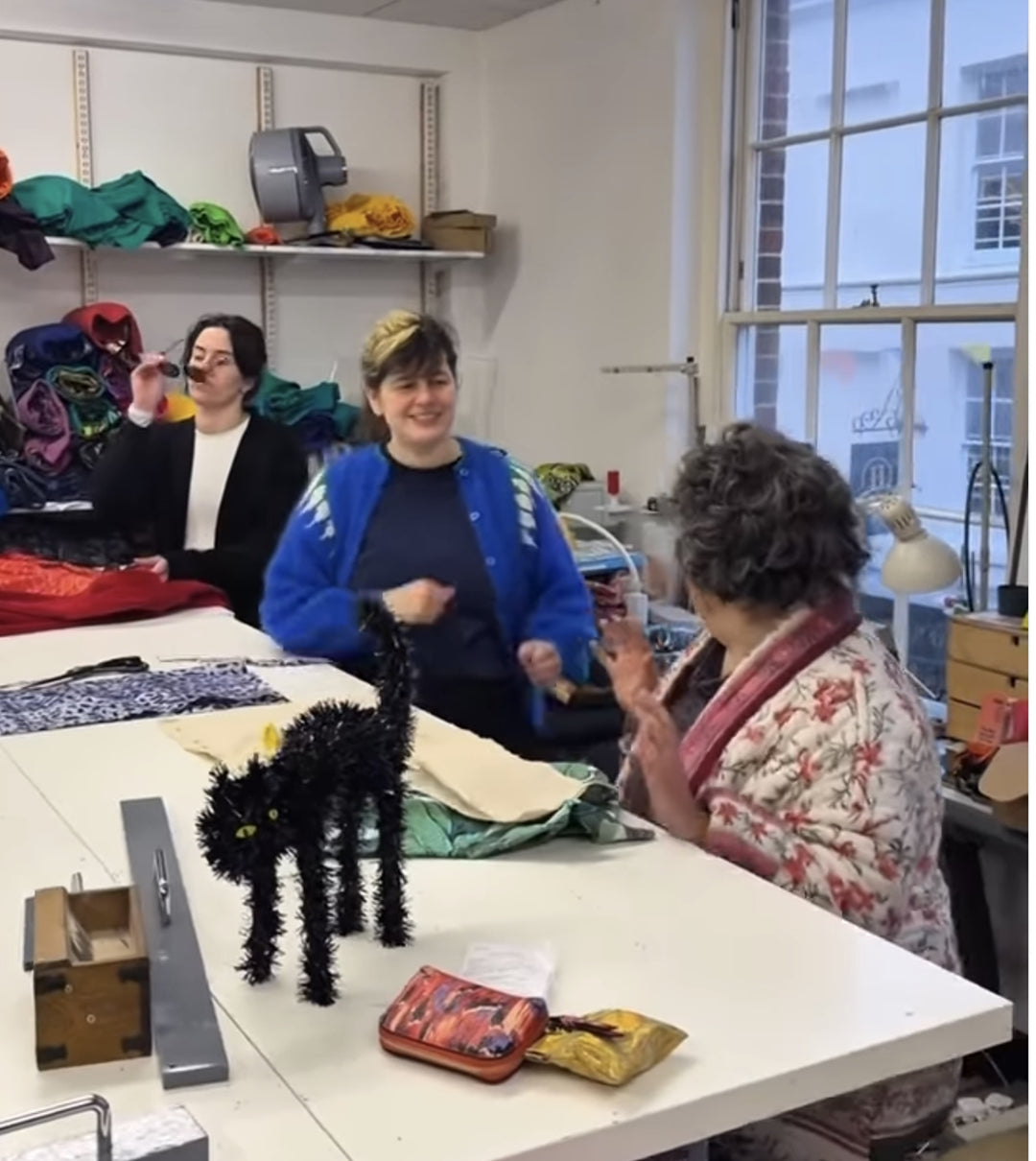 Makers laughing around the table in the Violet Elizabeth studio